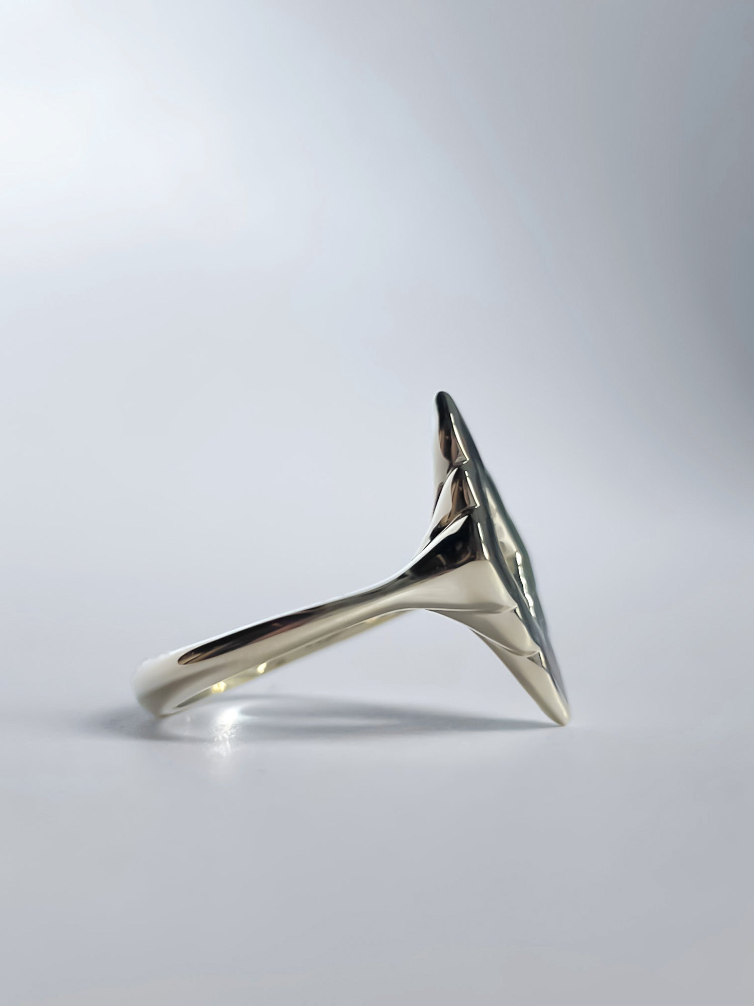 Side view of the Mirage Noir Ring, revealing its unique sculptural contours and bold design, available in 14K or 18K gold.