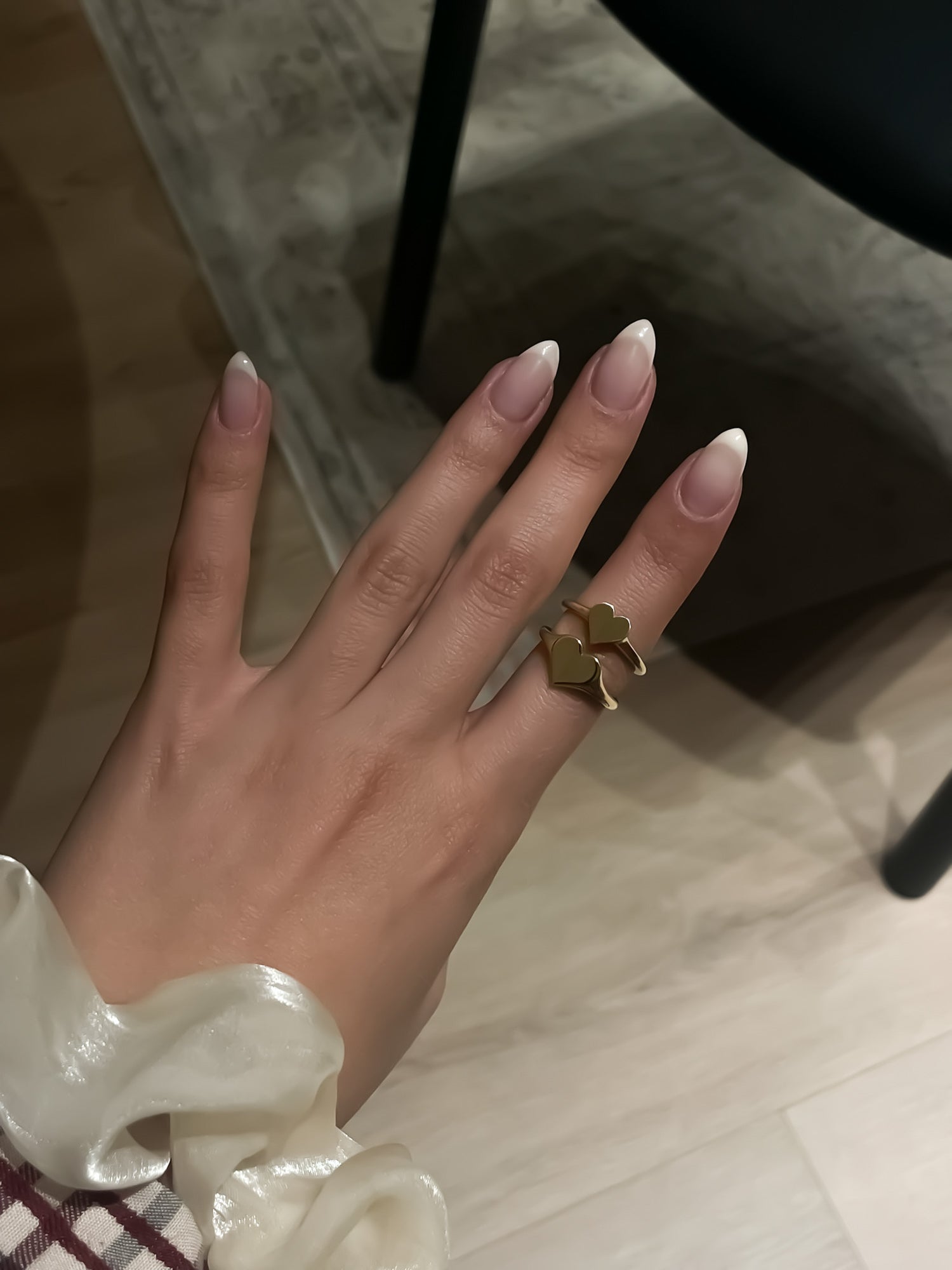 Close-up of a model wearing the Little Heart and FIne Heart Signet Rings by Presiada, crafted in 14K or 18K gold. A refined, delicate heart design that symbolizes love and elegance, perfect for everyday wear. Available in yellow or white gold.