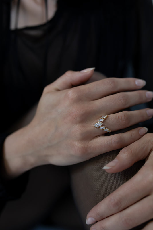 Close-up of the J’ador V-Flame ring by Presiada, crafted in 18K gold. The V-shaped design features marquise diamonds arranged elegantly to create a bold and sophisticated look. This unique ring is perfect for engagements or special occasions, available in natural or lab-grown diamonds.