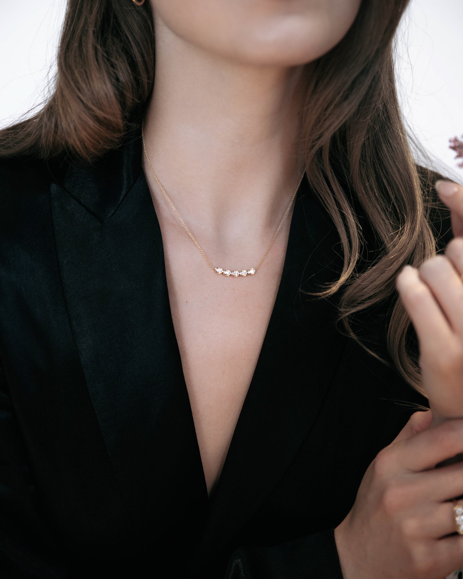 Model wearing the Vines of Florence necklace by Presiada, crafted in 18K gold with pear-shaped diamonds totaling approximately 0.5-0.6 ct. The necklace features a vine-inspired design that sparkles elegantly on the neck, blending timeless elegance with a modern, romantic touch. Available in lab-grown diamonds on the website or natural diamonds upon request, this piece evokes the magic of the Florentine Renaissance.