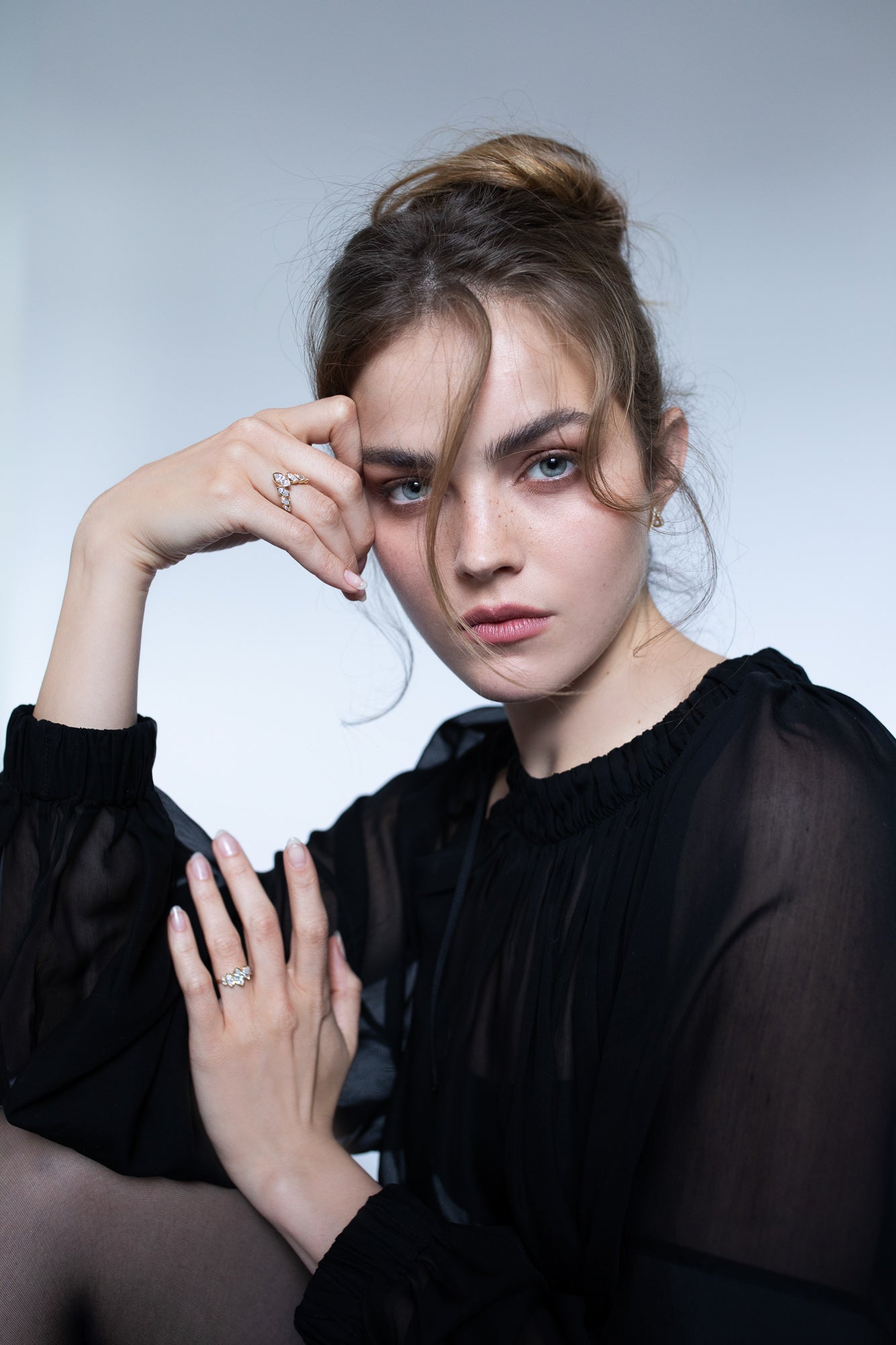 Elegant image of a model wearing Presiada's VIVID 18K gold earrings from the Sensation Collection, paired with two stunning engagement rings, J'ador V Flam and La Divine. These exquisite pieces, crafted with natural diamonds, highlight timeless luxury and modern sophistication, perfect for engagements and special occasions.