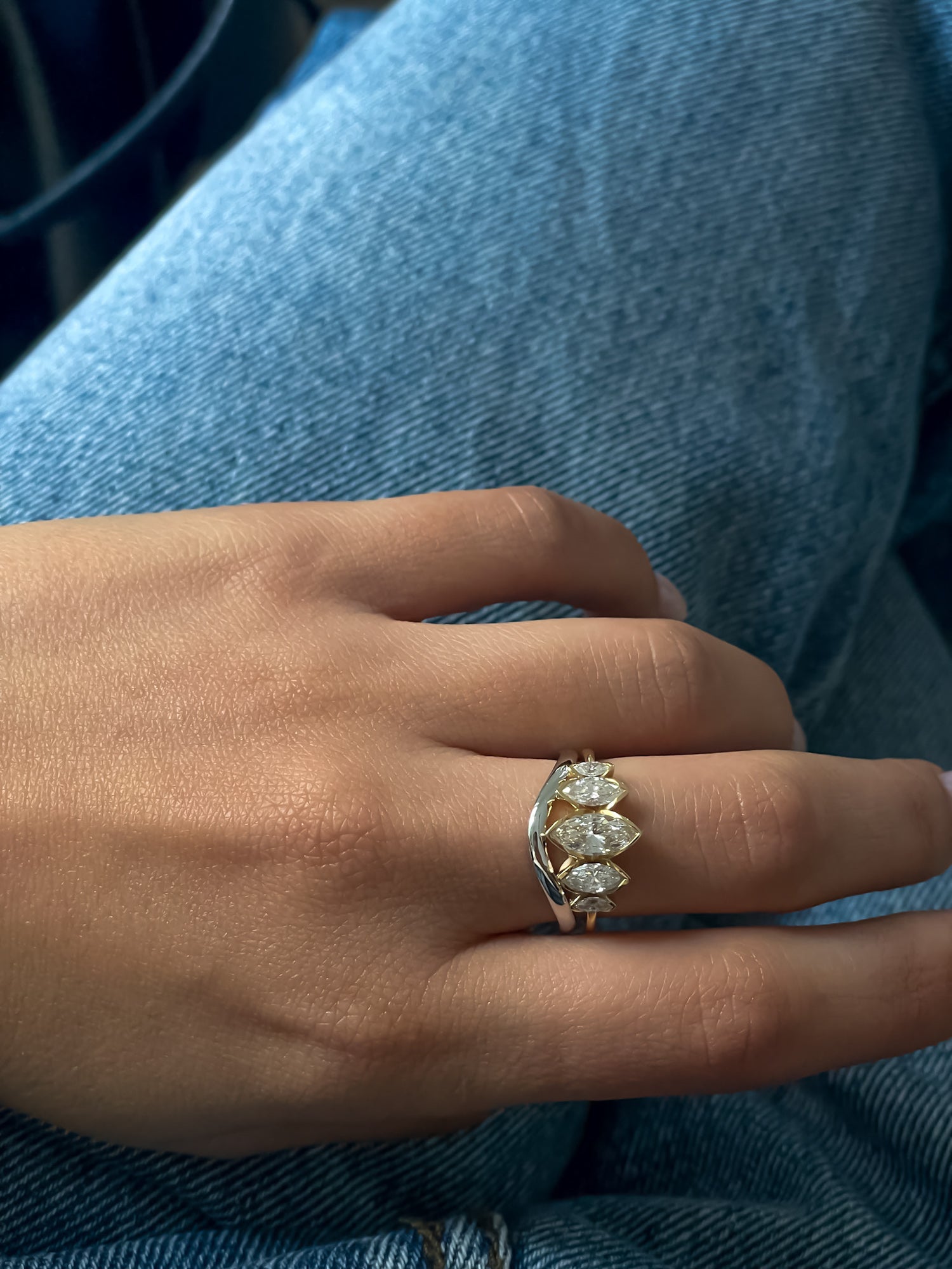 A model showcasing the Wave Ring with La Divine Lab or Natural Diamonds Engagement Ring by Presiada, a sculptural twisted band crafted in 14K or 18K gold. This elegant yet modern wedding band perfectly complements engagement rings or stands alone as a timeless statement.