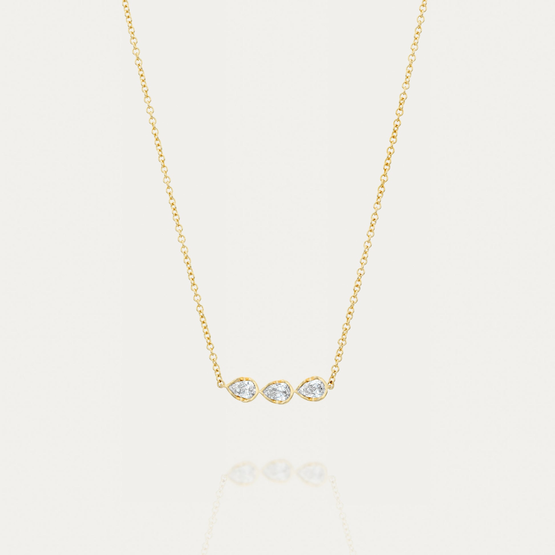 Product image of the Vines of Florence necklace featuring three pear-shaped diamonds set in an 18k yellow gold chain. This elegant and minimalist design highlights approximately 0.35 ct of sparkling diamonds, available in lab-grown or natural options.