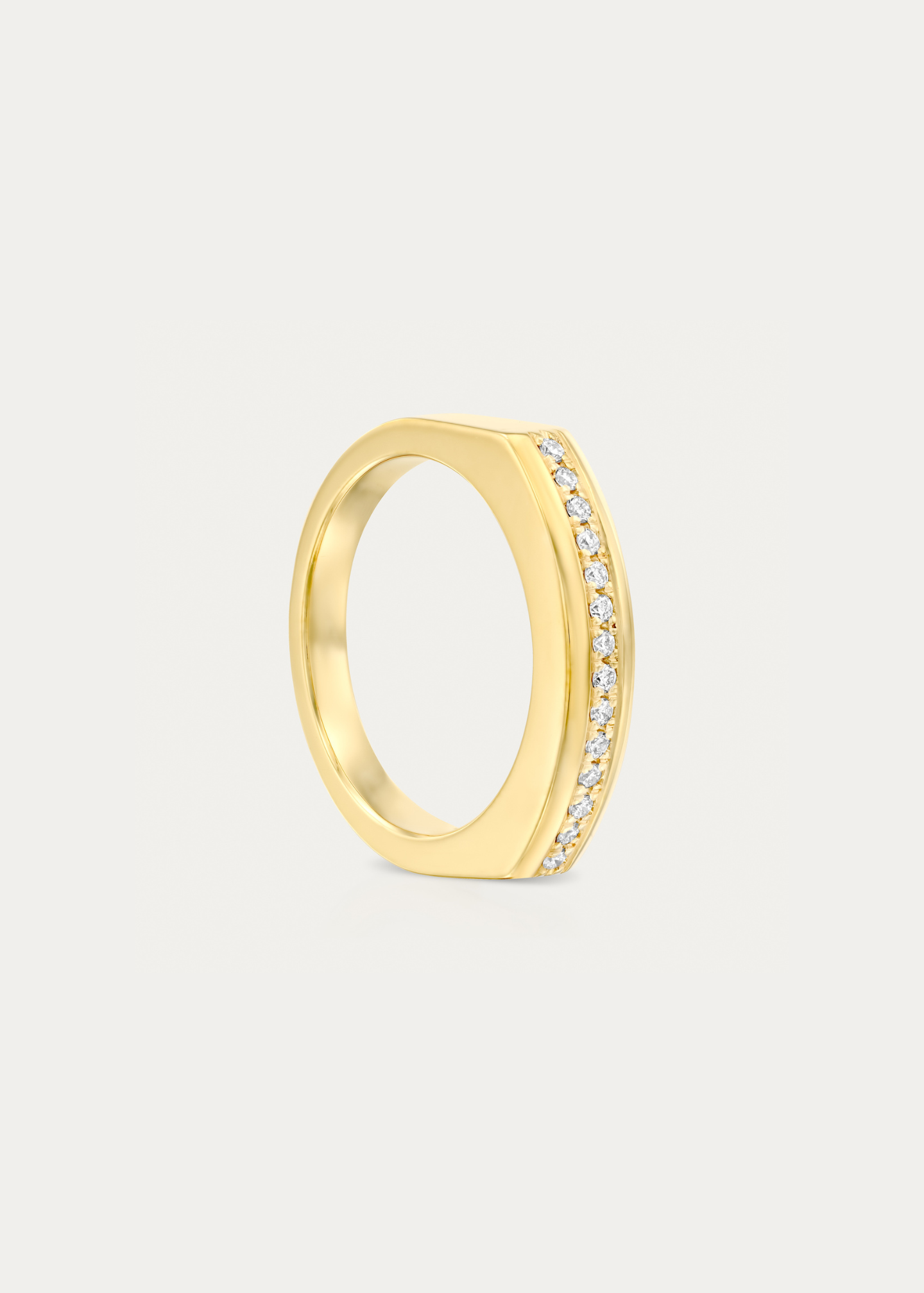 Side view of the 18k gold arc ring featuring pavé-set diamonds along its bold and contemporary curved design