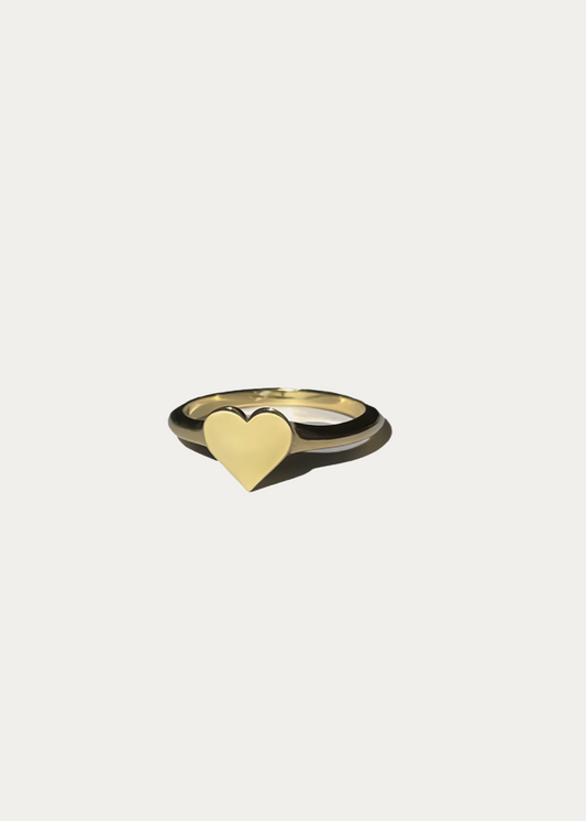 High-resolution packshot of the Little Heart Signet Ring by Presiada. Crafted in 14K or 18K gold, this delicate heart-shaped ring symbolizes love and elegance. Available in yellow or white gold, perfect for everyday wear.