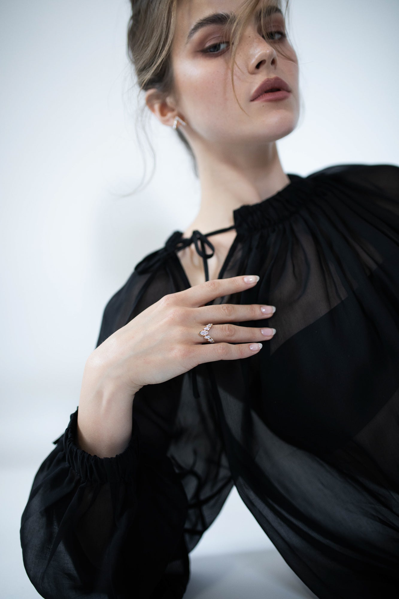 odel wearing the J’ador V-Flame ring by Presiada, crafted in 18K gold. This elegant ring features a unique V-shaped design with marquise diamonds, combining timeless beauty with a bold modern touch. Perfect for engagements or special occasions, it is available in natural or lab-grown diamonds for a personalized style.