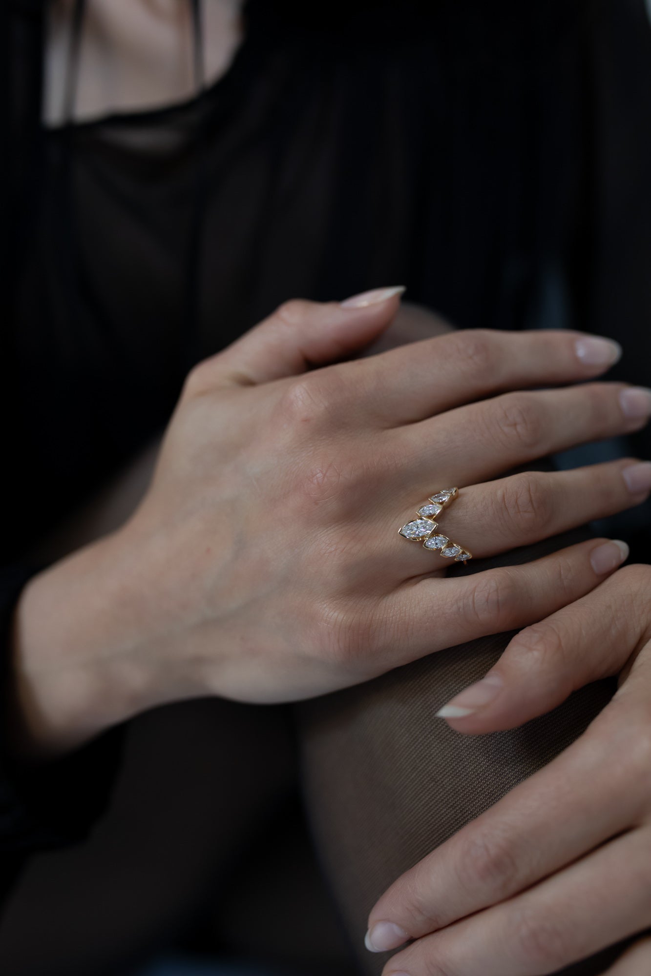 Close-up of the J’ador V-Flame ring by Presiada, crafted in 18K gold. The V-shaped design features marquise diamonds arranged elegantly to create a bold and sophisticated look. This unique ring is perfect for engagements or special occasions, available in natural or lab-grown diamonds.
