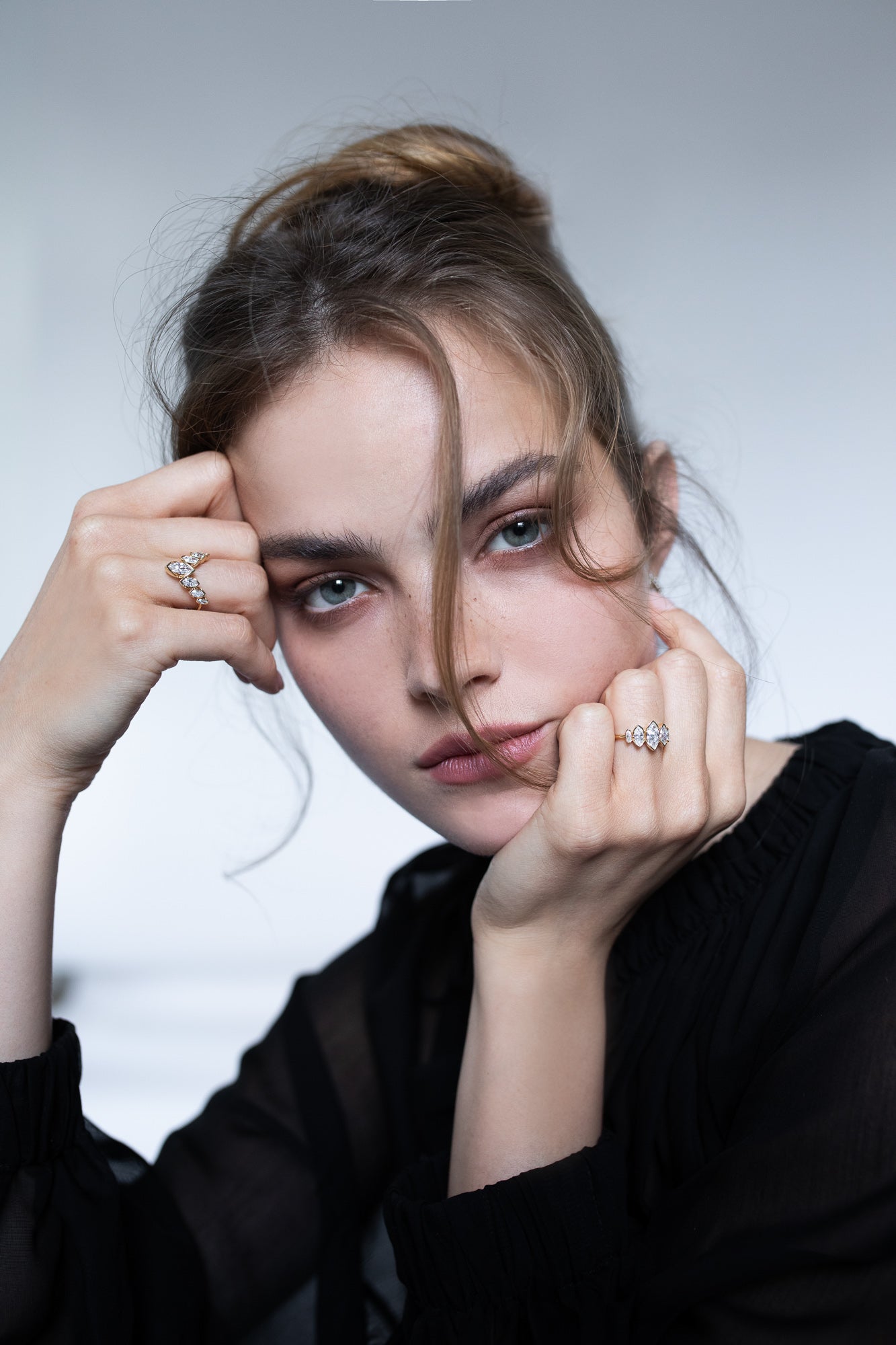 Elegant image of a model wearing Presiada's VIVID 18K gold earrings from the Sensation Collection, paired with two stunning engagement rings, J'ador V Flam and La Divine. These exquisite pieces, crafted with natural diamonds, highlight timeless luxury and modern sophistication, perfect for engagements and special occasions.