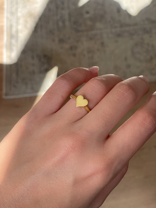 Close-up of a model wearing the Little Heart Signet Ring by Presiada, crafted in 14K or 18K gold. A refined, delicate heart design that symbolizes love and elegance, perfect for everyday wear. Available in yellow or white gold.